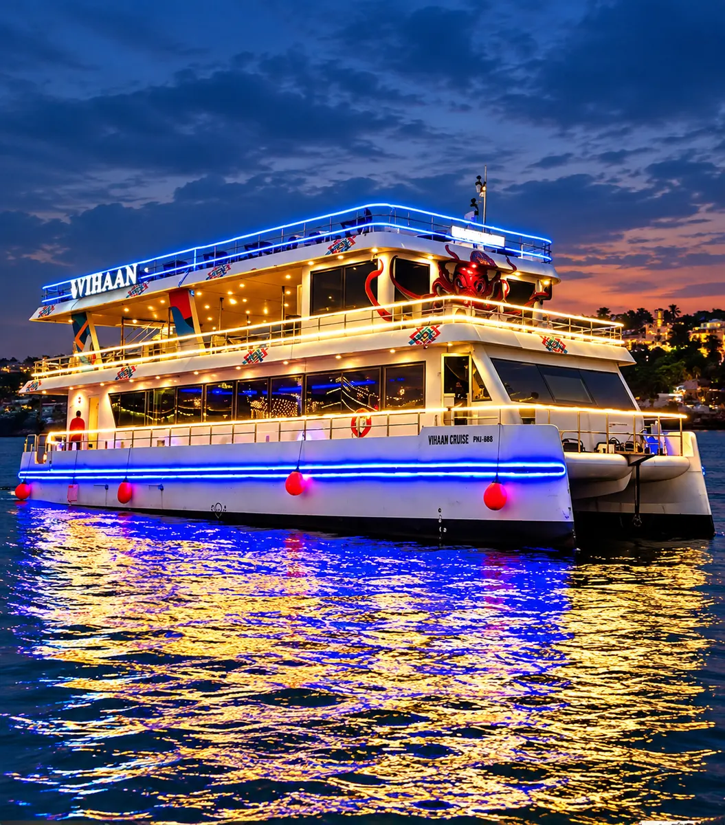 Vihan Luxury Dinner Cruise illuminated on the Mandovi River at dusk