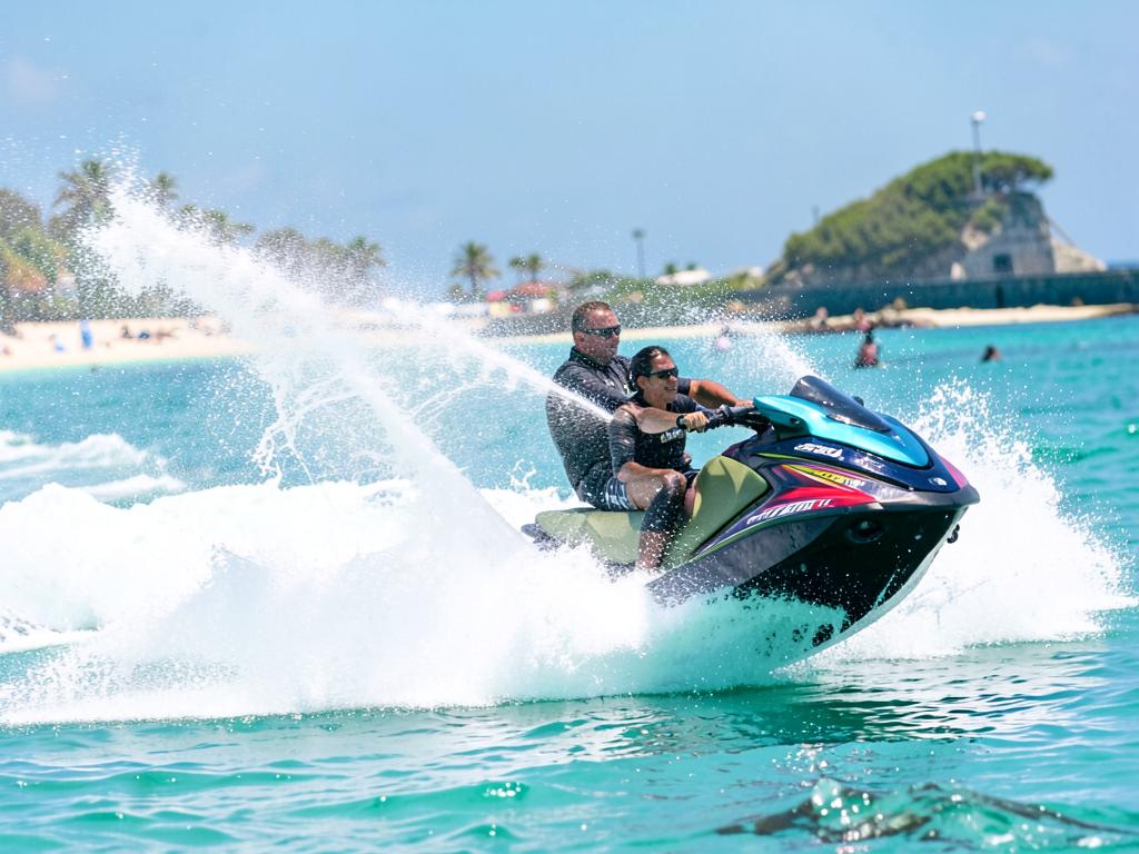 Jet ski spraying salt water across a turquoise bay
